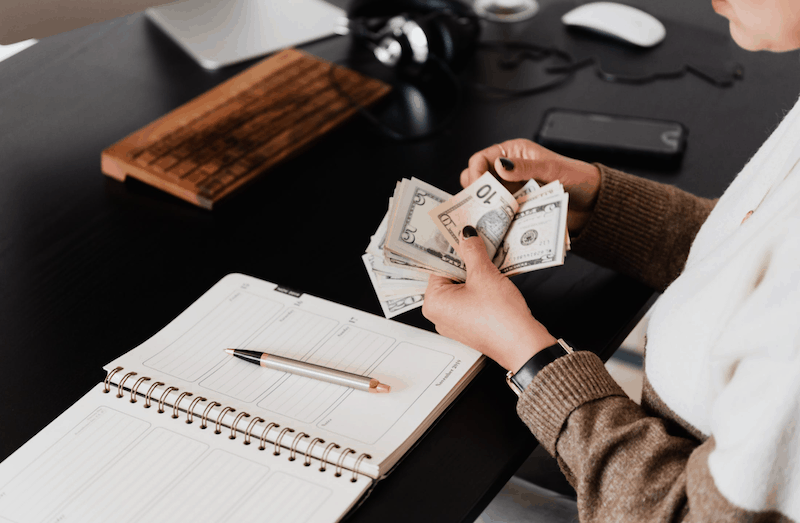 Woman counting her money and budgeting 