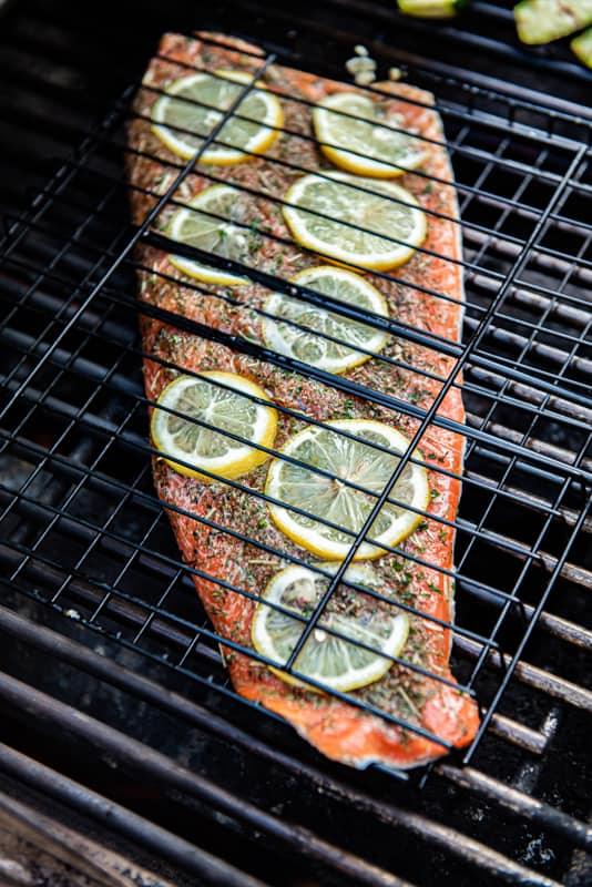 Grilled steelhead trout in grill cage